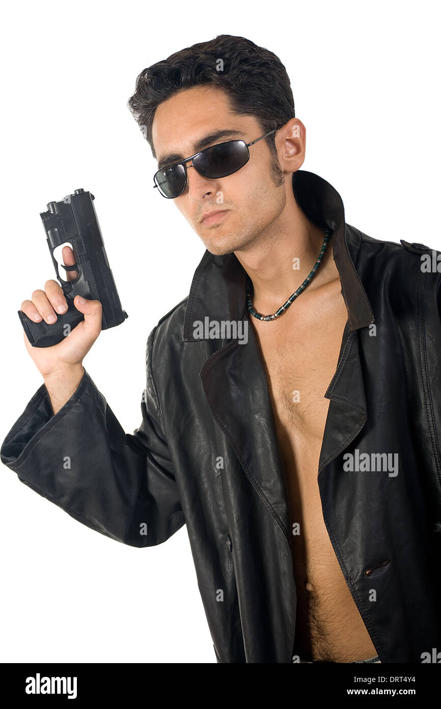 Handsome man with gun in leather raincoat Stock Photo