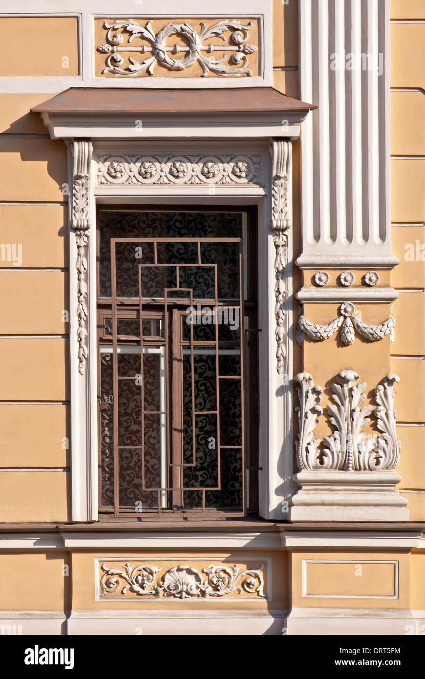 Window Relief Design A window with white bas-relief and grating on the background of beige ...