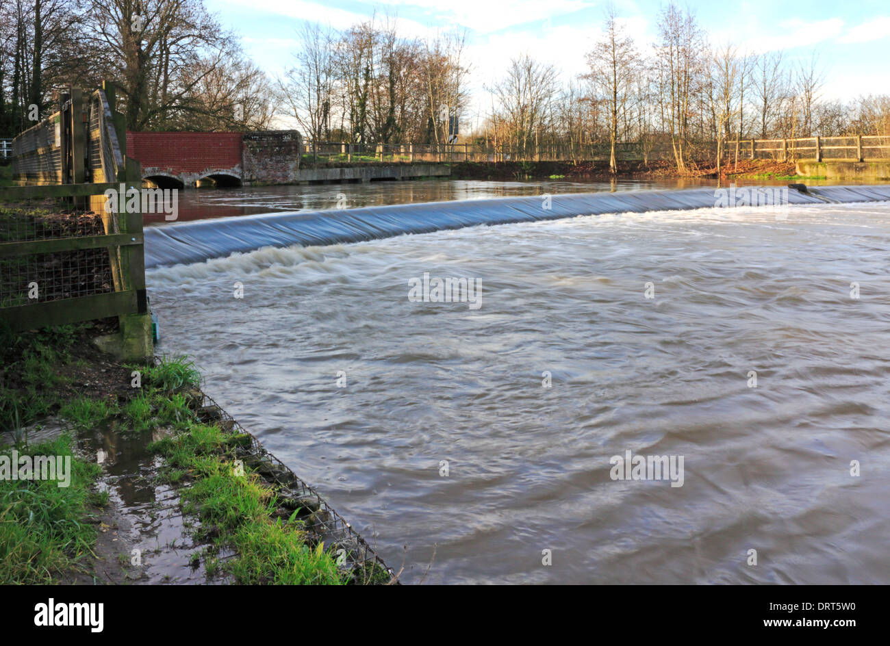 The weir and road bridge on the River Wensum at Costessey Mill, Norfolk, England, United Kingdom. Stock Photo