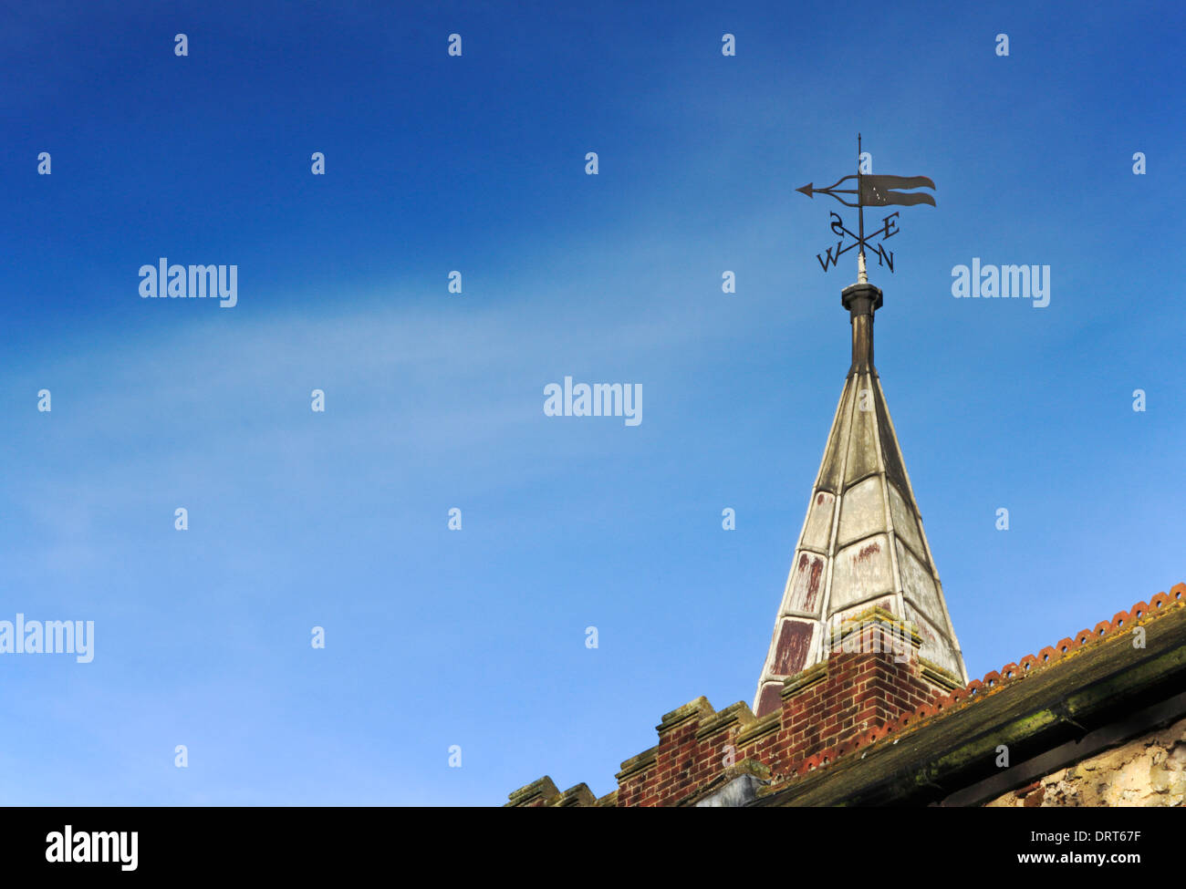 A view of the small spire and weather vane on the tower of the church of St Edmund at Costessey, Norfolk, England, UK. Stock Photo