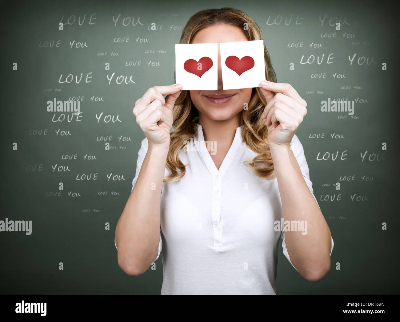 Portrait of attractive woman with two paper cards with red hearts ...
