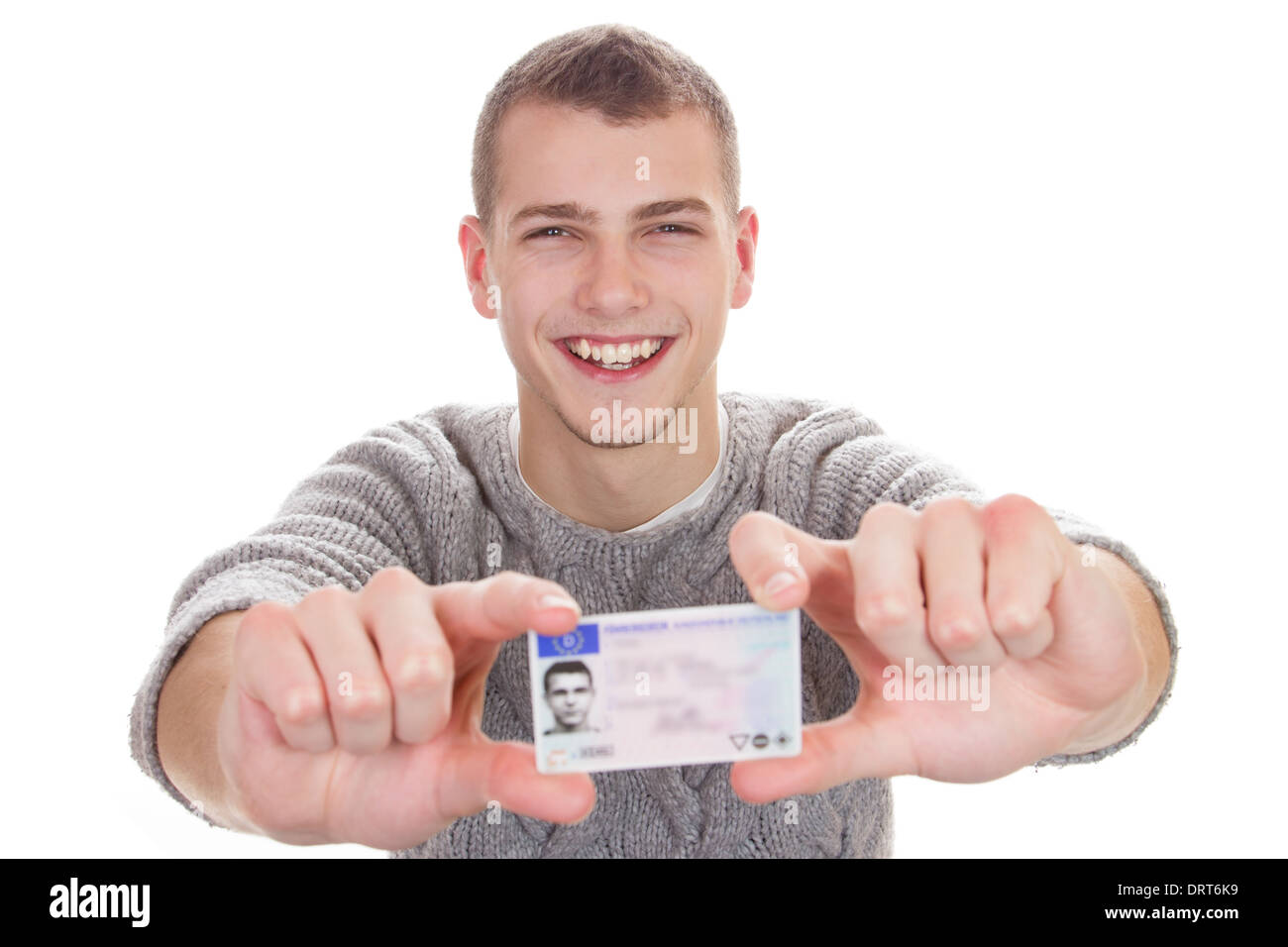 16 to 18 year old boy just received his driver license Stock Photo