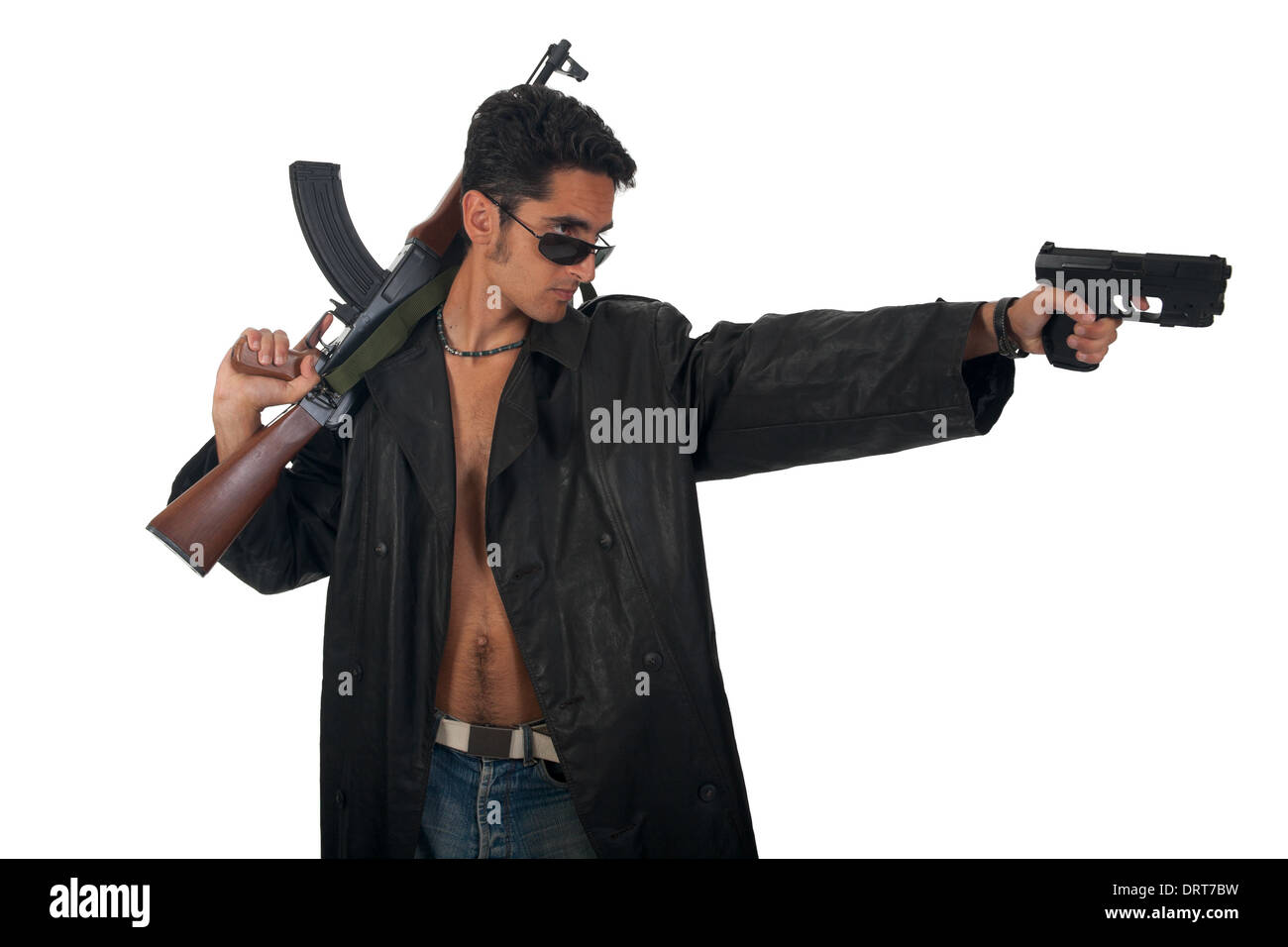 Handsome man with gun in leather raincoat. Stock Photo