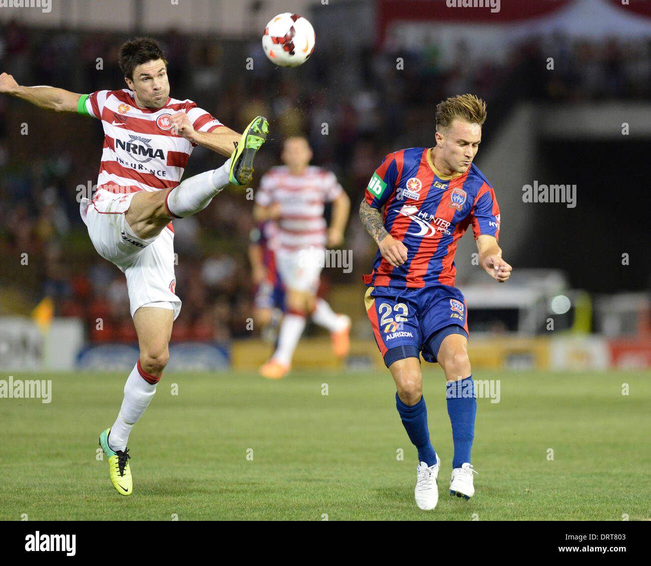 Sydney, Australia. 1st Feb, 2014. Wanderers captain Michael Beauchamp and Jets forward Adam Taggart in action during the Hyundai A League game between the Newcastle Jets FC and Western Sydney Wanderers FC from the Hunter Stadium, Newcastle. The match ended in a 2-2 draw. Credit:  Action Plus Sports Images/Alamy Live News Stock Photo