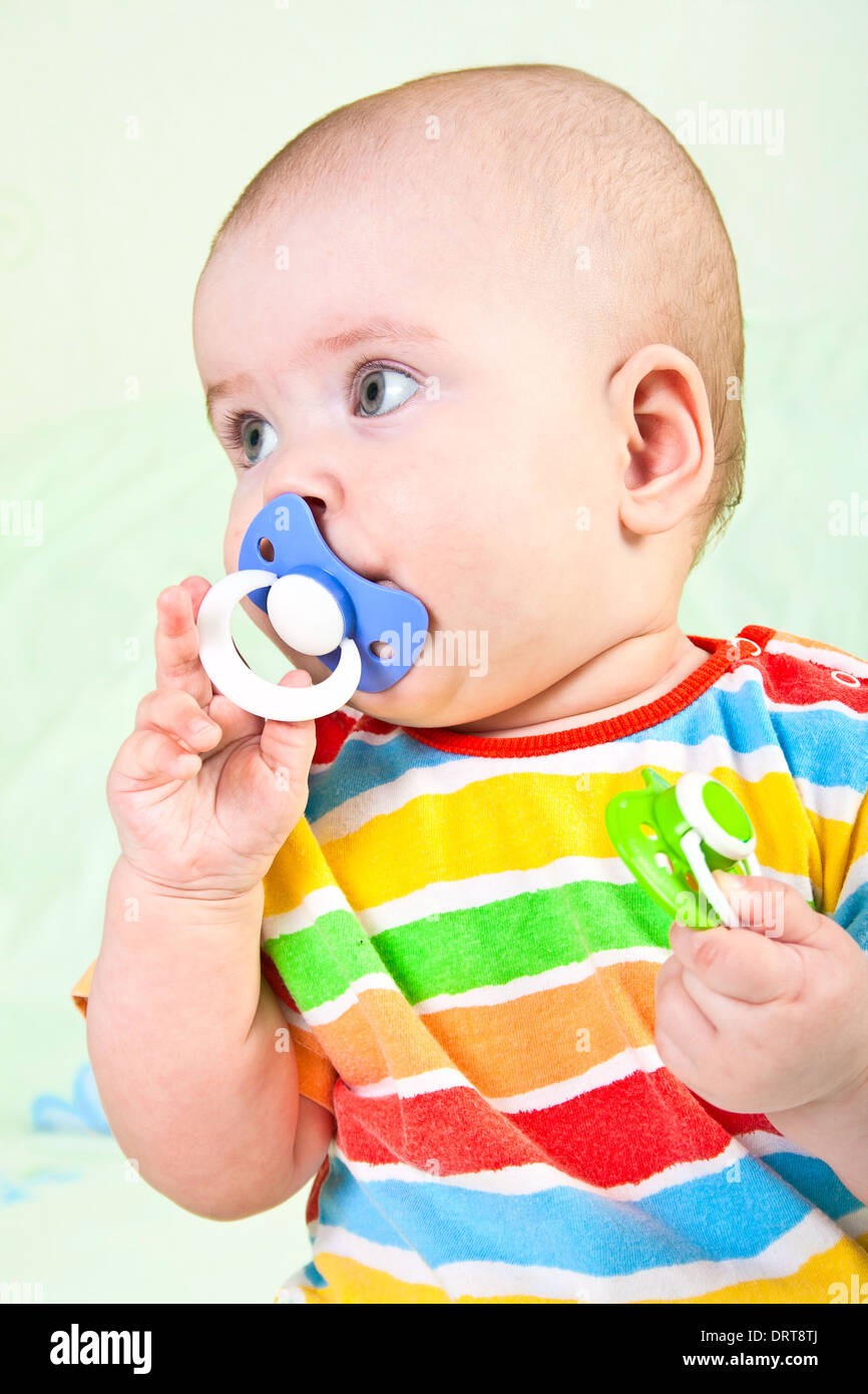 Baby girl with pacifier. Stock Photo