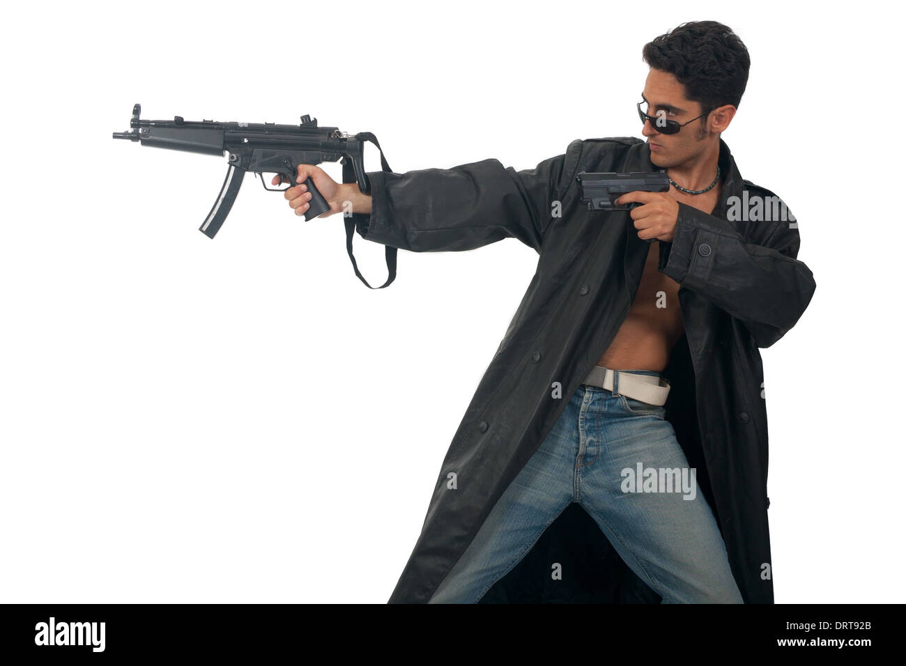 Handsome man with gun in leather raincoat. Stock Photo