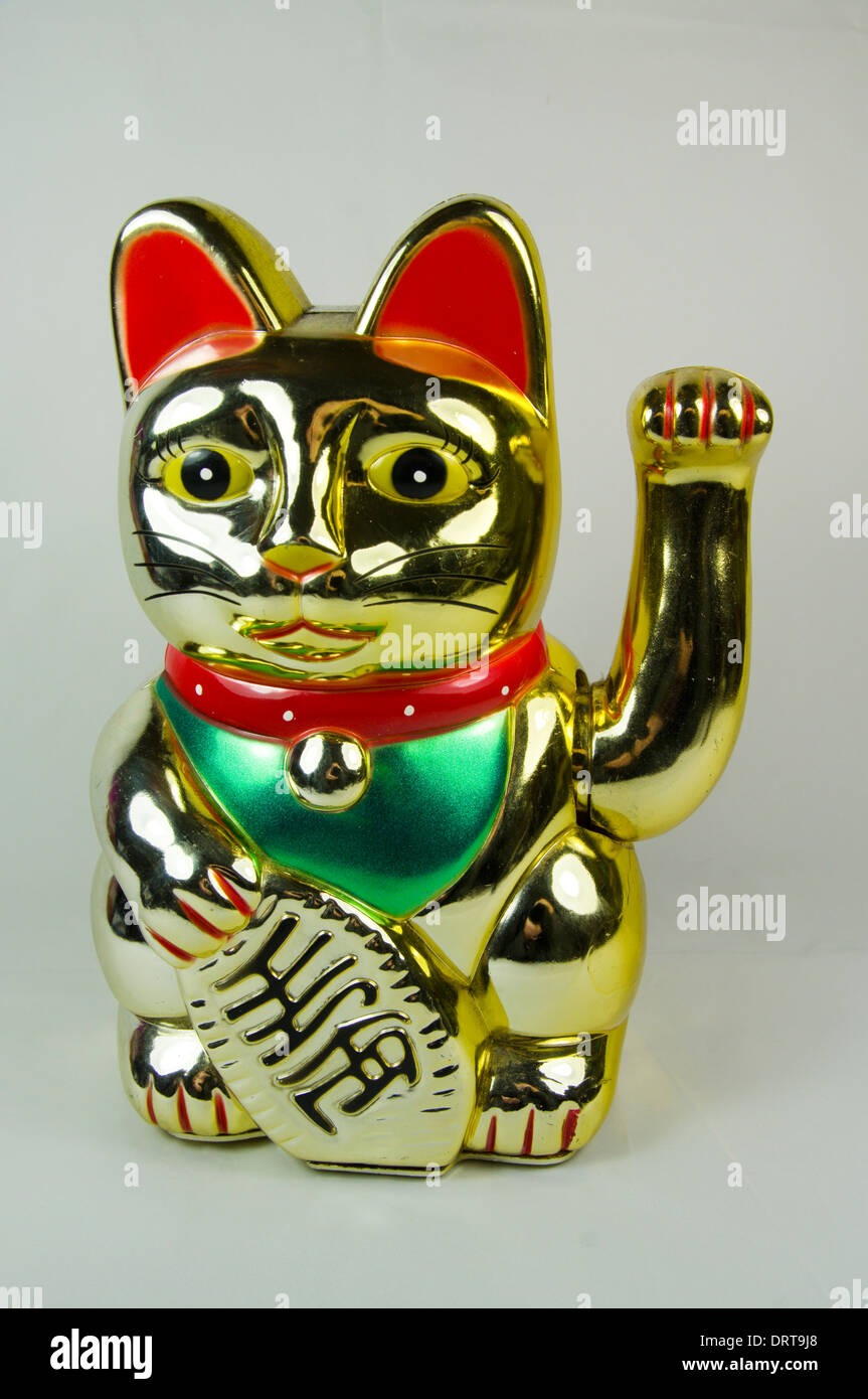 Maneki Neko Japanese Waving or Beckoning Cat, good luck charm. Stock Photo