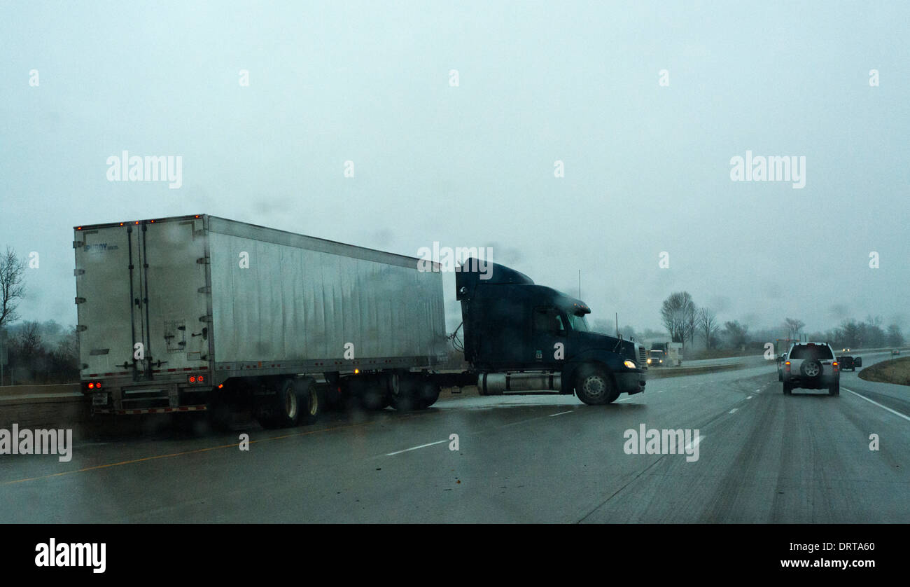 Jack knifed truck on Interstate 80 during icy rain and dangerous driving conditions. Stock Photo