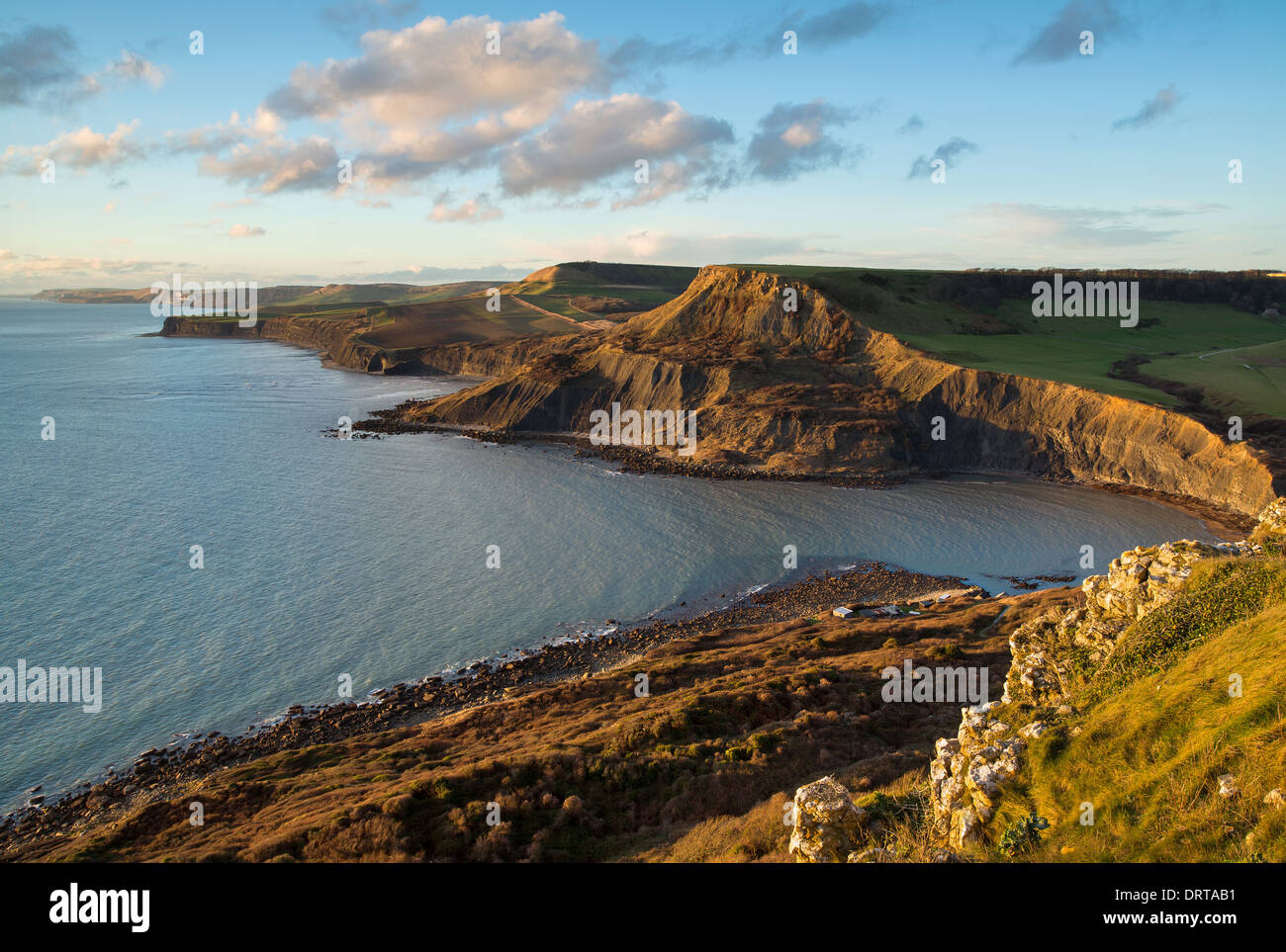Fabulous late afternoon view across Chapman's Pool with the sun reflecting off the face of Houns-tout Cliff. Dorset, UK Stock Photo