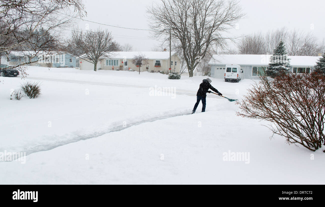 Man shoveling driveway after snowfall. Stock Photo