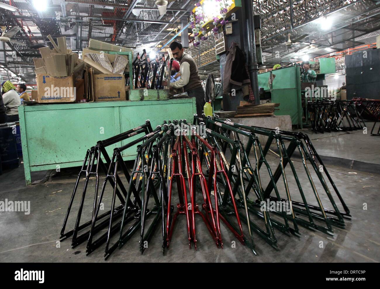 (140201) -- PUNJAB, Feb. 1, 2014 (Xinhua) -- Workers make bicycle parts at a factory at Ludhina in Indian state of Punjab, Feb. 1, 2014. The north Indian state is the hub of bicycle manufacturing. Officials said 40,000-50,000 bicycles are manufactured in the city everyday and exported to Indian states and other countries. The state has around 4000 registered small and large units associated with making bicycle parts. (Xinhua/Javed Dar) Stock Photo