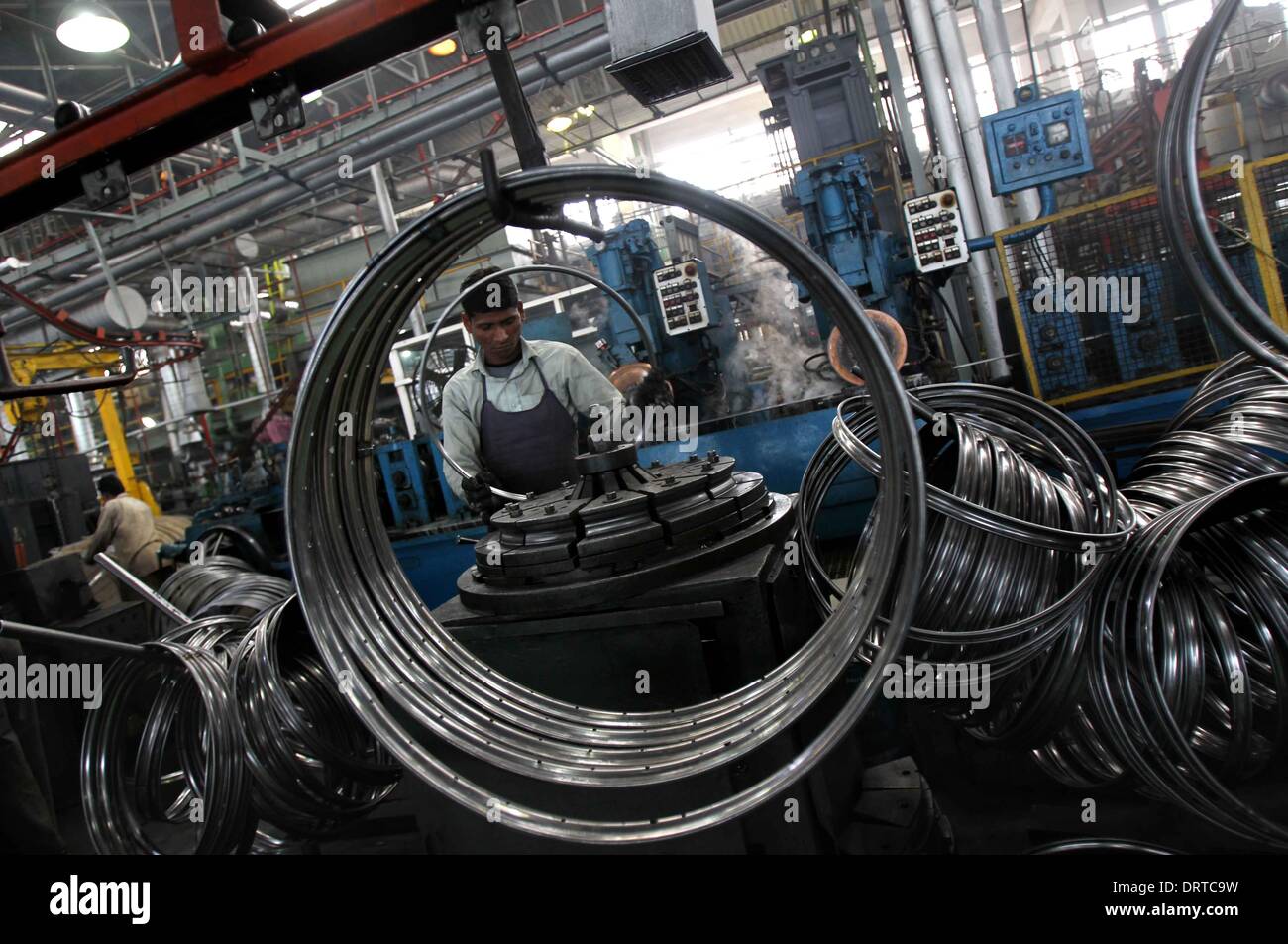 (140201) -- PUNJAB, Feb. 1, 2014 (Xinhua) -- Workers make bicycle parts at a factory at Ludhina in Indian state of Punjab, Feb. 1, 2014. The north Indian state is the hub of bicycle manufacturing. Officials said 40,000-50,000 bicycles are manufactured in the city everyday and exported to Indian states and other countries. The state has around 4000 registered small and large units associated with making bicycle parts. (Xinhua/Javed Dar) Stock Photo