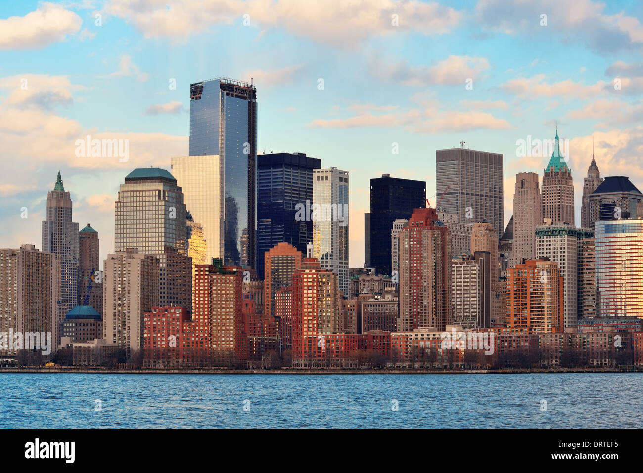 Downtown Manhattan skyline at sunset over Hudson River in New York City ...