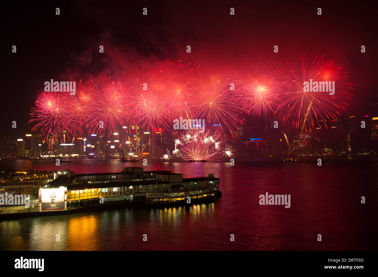Firework explode over Victoria Harbour in Hong Kong on February 1, 2014 as China Celebrates the year of the Horse. Stock Photo