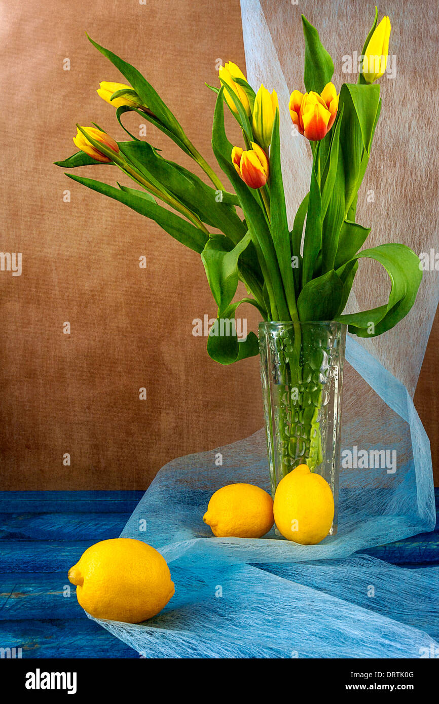 Still life with a bouquet of tulips and lemons Stock Photo - Alamy
