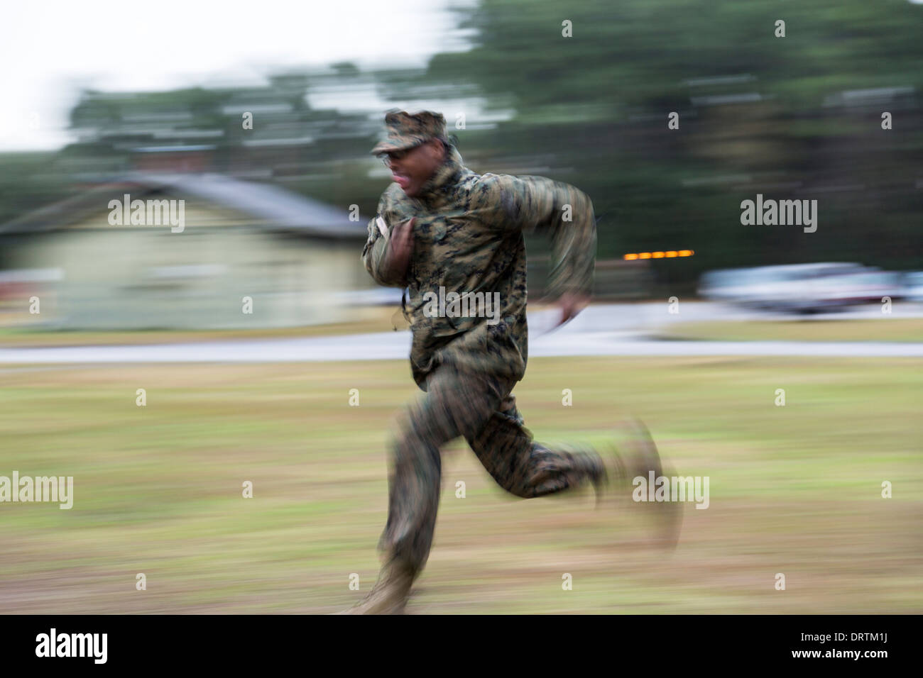 US Marine runs at the command of a drill sergeant during boot camp January 13, 2014 in Parris Island, SC. Stock Photo