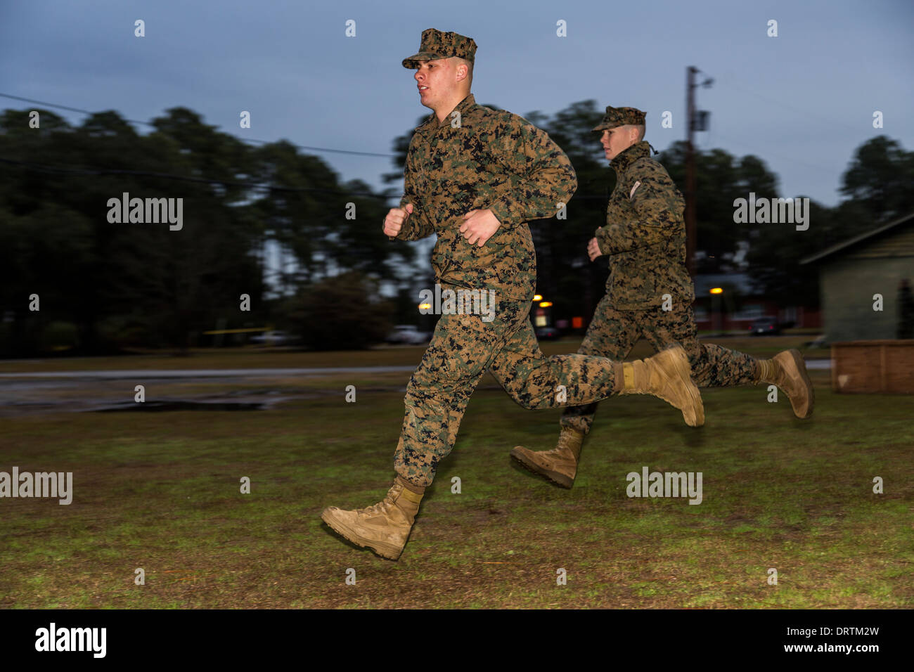 US Marine runs at the command of a drill sergeant during boot camp January 13, 2014 in Parris Island, SC. Stock Photo