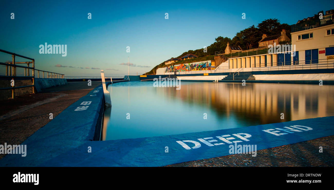 Shoalstone outdoor saltwater swimming pool at Brixham in South Devon during an early evening sunset. Stock Photo