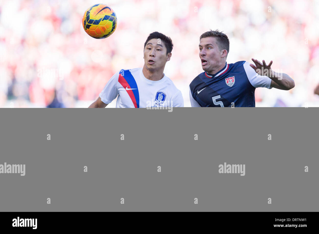 Carson, CA, USA. 1st Feb, 2014.  South Korea forward Lee Keun-Ho (11) and USA defender Matt Besler (5) fight for the ball in the first half during the game between USA and South Korea at the StubHub center in Carson, CA. Credit:  csm/Alamy Live News Stock Photo