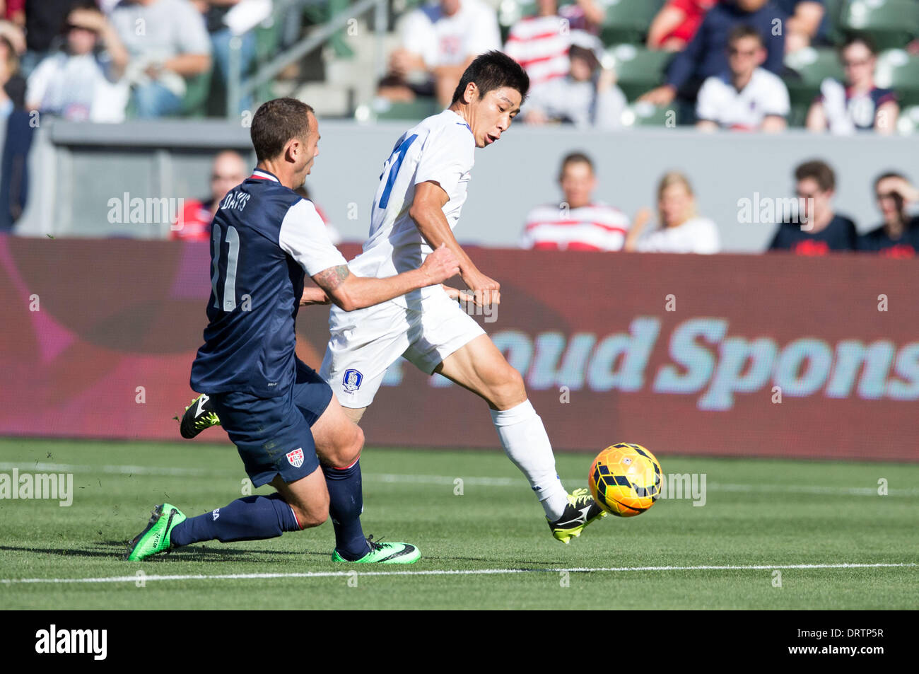 Carson, CA, USA. 1st Feb, 2014.  South Korea forward Lee Keun-Ho (11) moves the ball past USA midfielder Brad Davis (11) in the first half during the game between USA and South Korea at the StubHub center in Carson, CA. Credit:  csm/Alamy Live News Stock Photo
