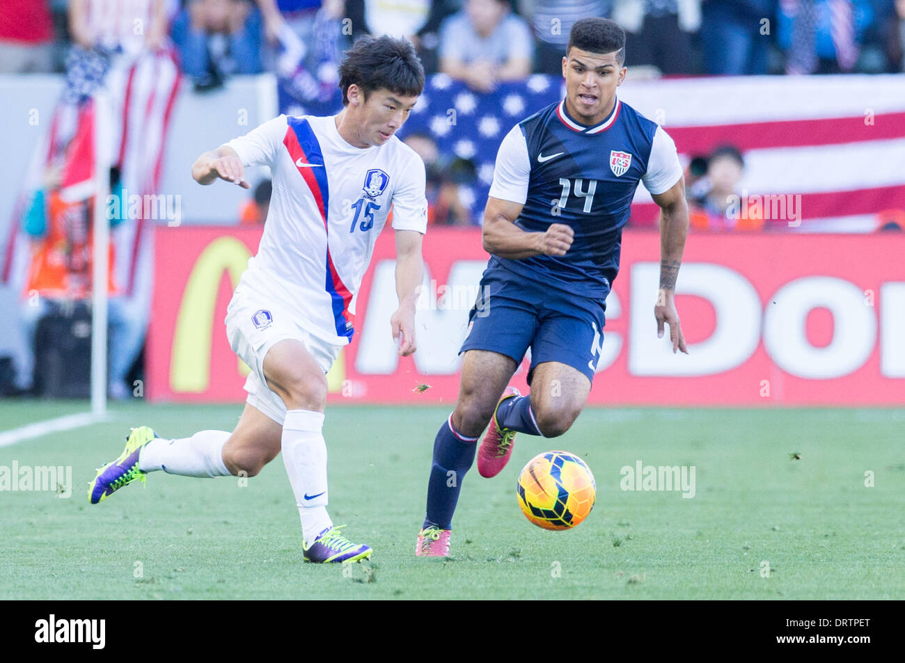Carson, CA, USA. 1st Feb, 2014.  South Korea midfielder Min-Woo Kim (15) moves the ball past USA defender DeAndre Yedlin (14) in the second half during the game between USA and South Korea at the StubHub center in Carson, CA. USA defeated South Korea 2-0 Credit:  csm/Alamy Live News Stock Photo