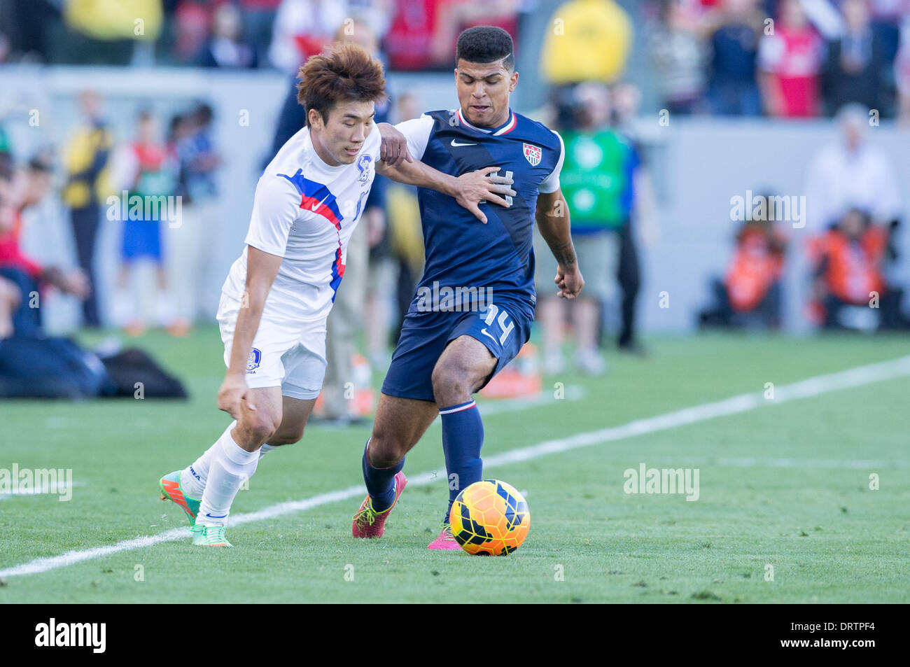 Carson, CA, USA. 1st Feb, 2014.  South Korea midfielder Ko Yo-Han (17) moves the ball past USA defender DeAndre Yedlin (14) in the second half during the game between USA and South Korea at the StubHub center in Carson, CA. USA defeated South Korea 2-0 Credit:  csm/Alamy Live News Stock Photo