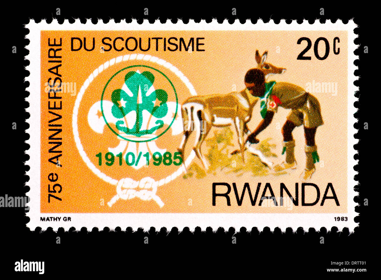 Postage stamp from Rwanda depicting a boy scout aiding a deer. Stock Photo