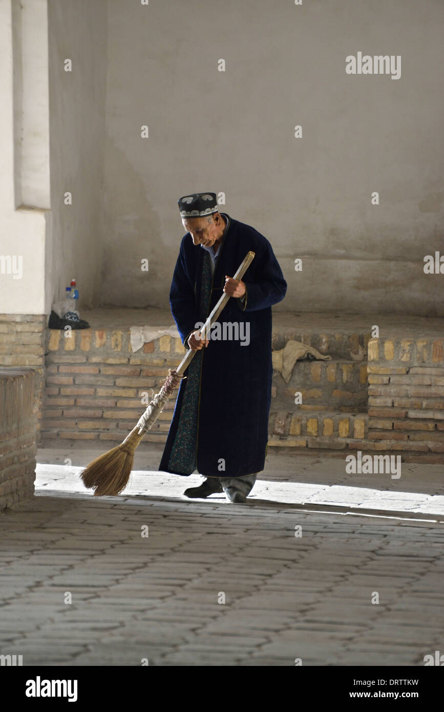 Man in traditional robe sweeping bazaar floor, Bukhara, Uzbekistan Stock  Photo - Alamy