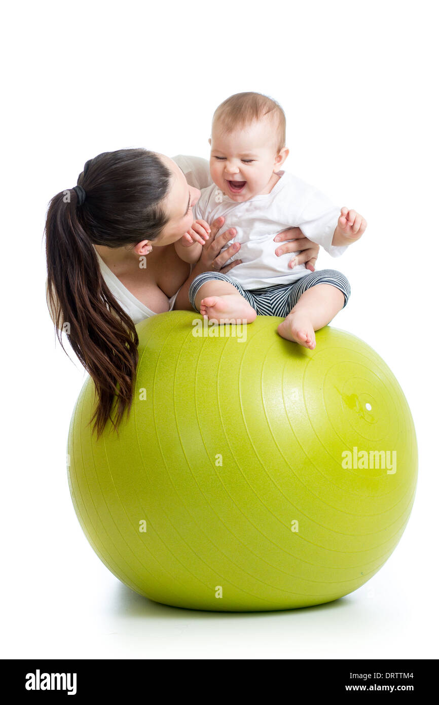 mother playing with baby on fit ball Stock Photo
