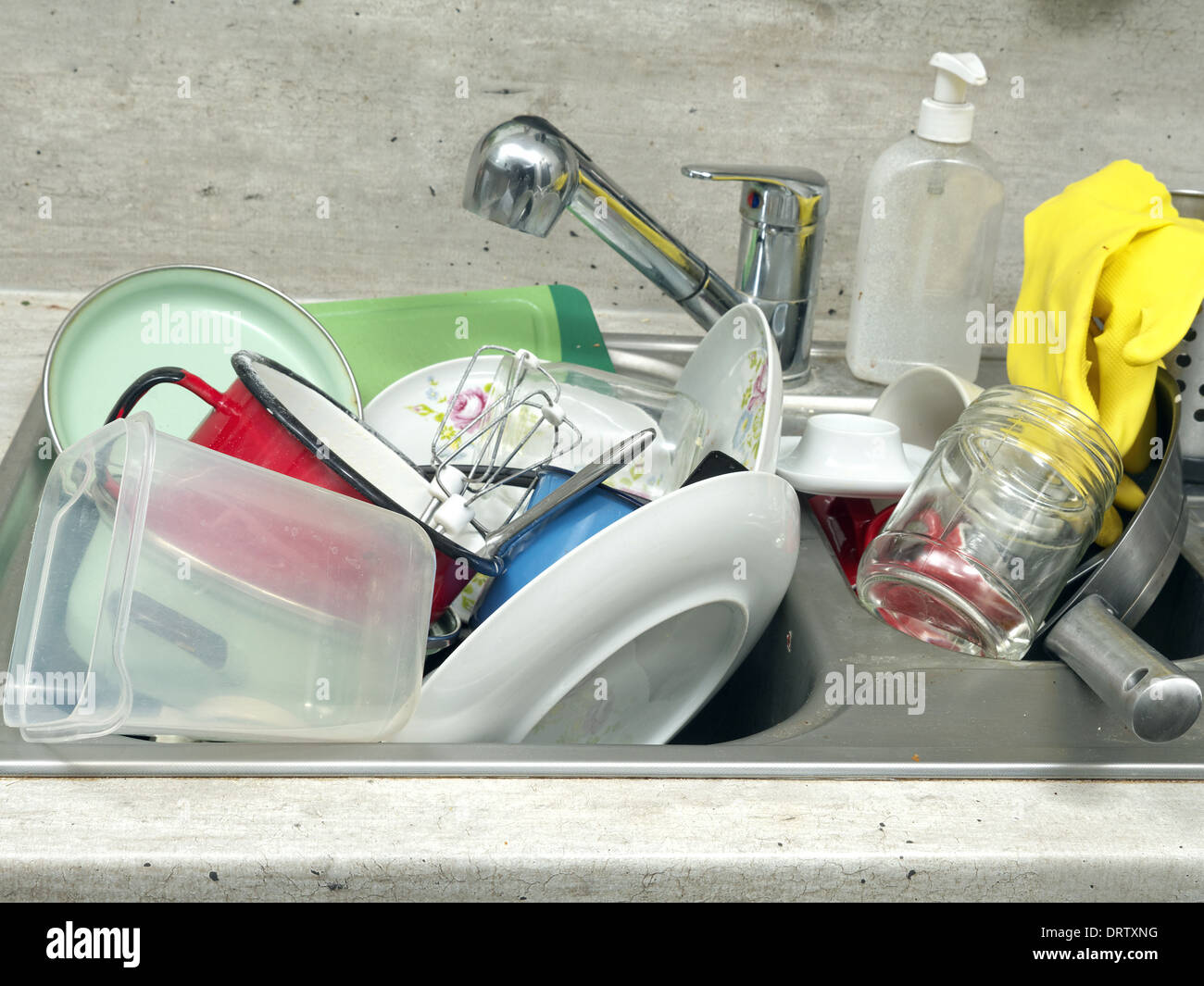 Kitchen sink full of dirty kitchenware Stock Photo