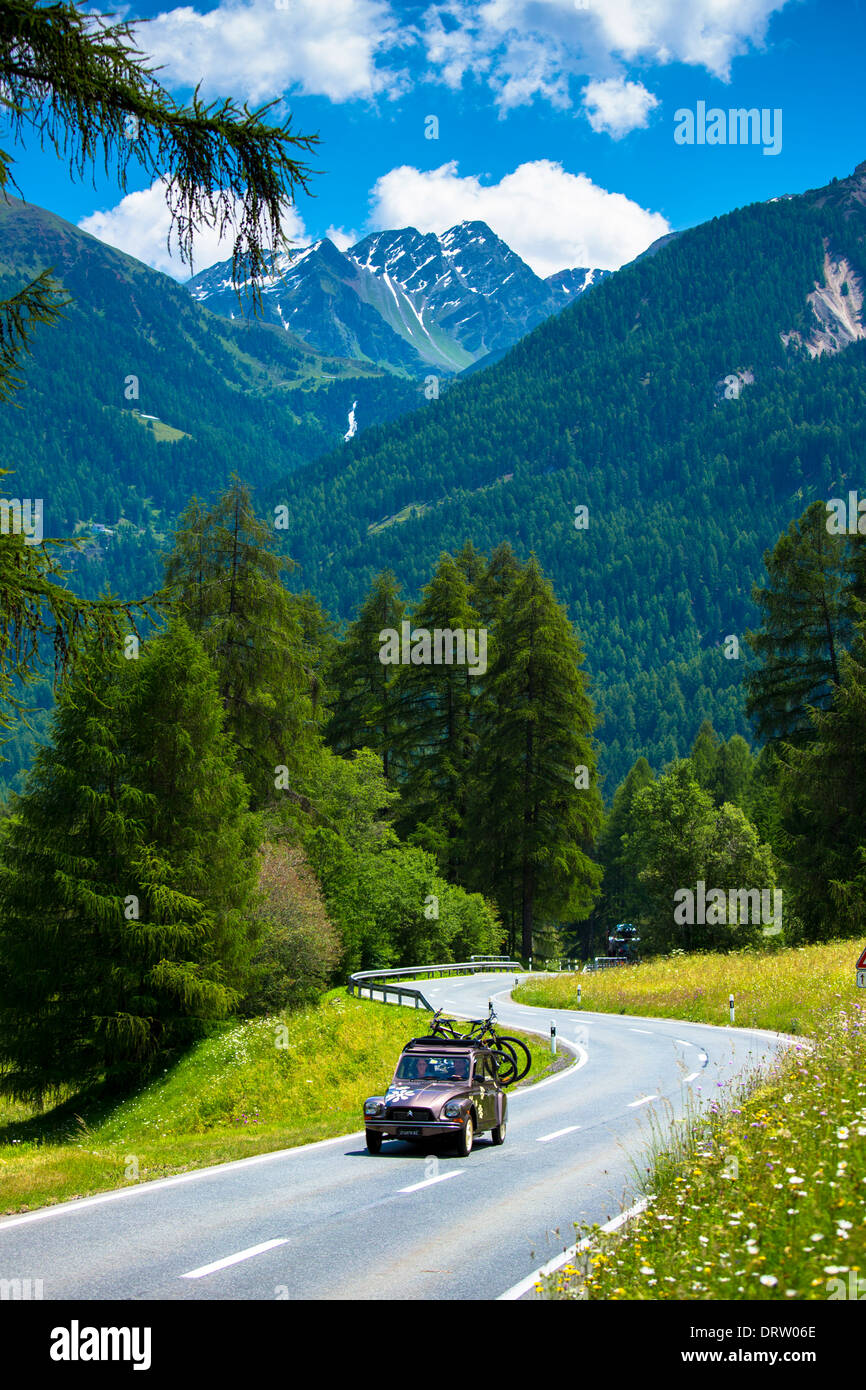 Citroen 2CV with bicycle rack on touring holiday in the Swiss Alps, Swiss National Park, Switzerland Stock Photo