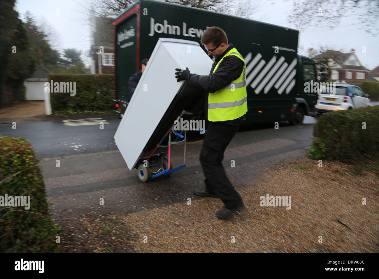 John Lewis Delivering A Freezer Men Using Sack Barrow To Move Heavy Freezer England Stock Photo