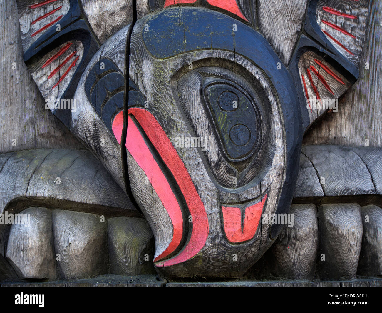 A detail of a carved wooden story pole standing to be found in Duncan, British Columbia Stock Photo