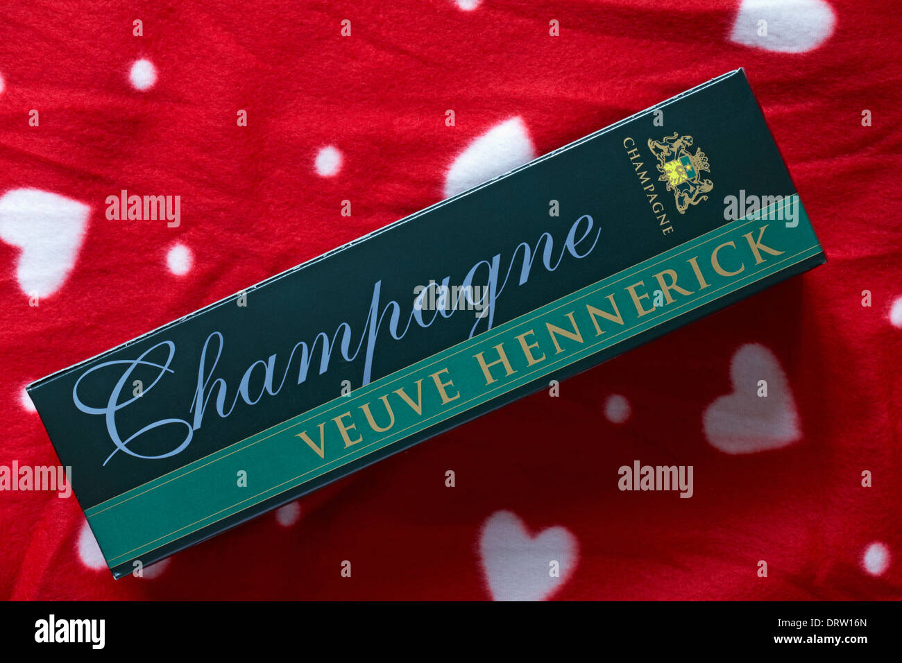 box of Veuve Hennerick Champagne set on red background with white hearts on Stock Photo