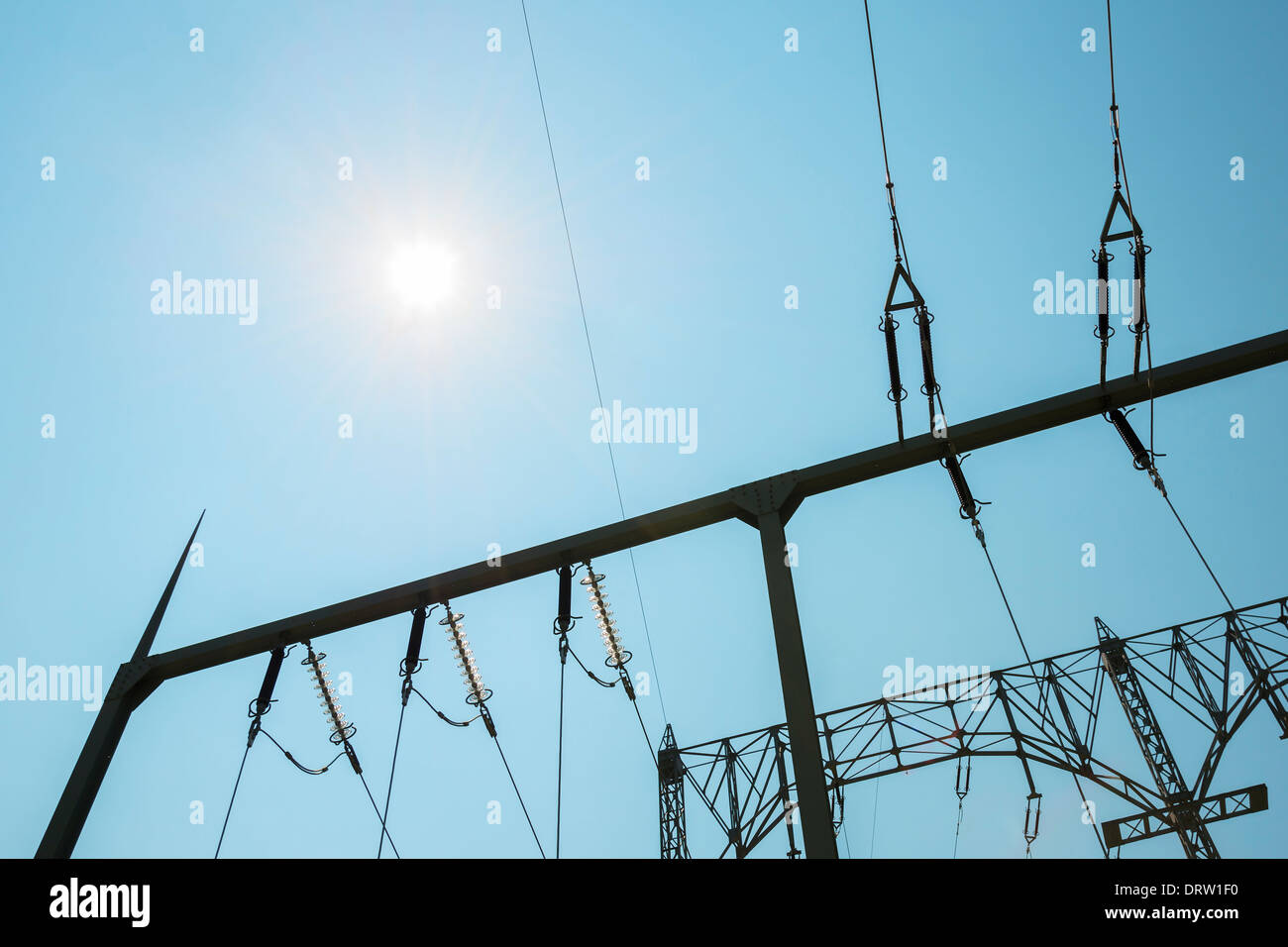 Elictricity pylon with blue sky and sun Stock Photo