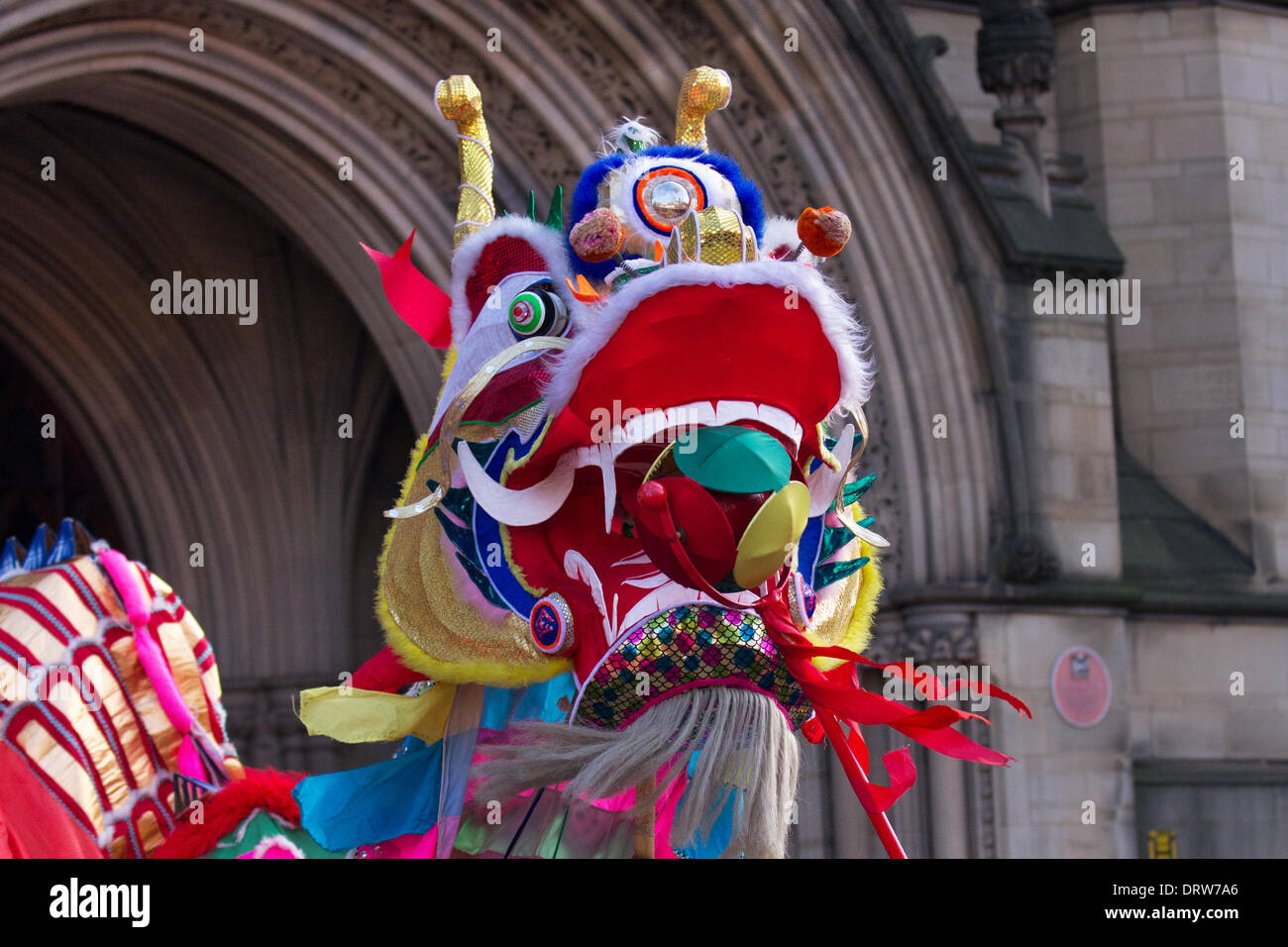 Chinese costume zodiac animals. Traditional golden New Year dragon dance festival in Chinatown Manchester, UK.  February, 2104. High pole lion dance at the  Chinese New Year in Albert Square, Manchester the North's biggest Chinese New Year celebrations. Manchester's Chinatown is one of Europe's biggest tucked into a narrow grid of streets behind Piccadilly Gardens.  With a 175-foot paper dragon, a lion dance, martial arts demonstrations, the Dragon Parade, from the Town Hall to Chinatown,  is one of the highlights of Manchester's annual events calendar. Stock Photo