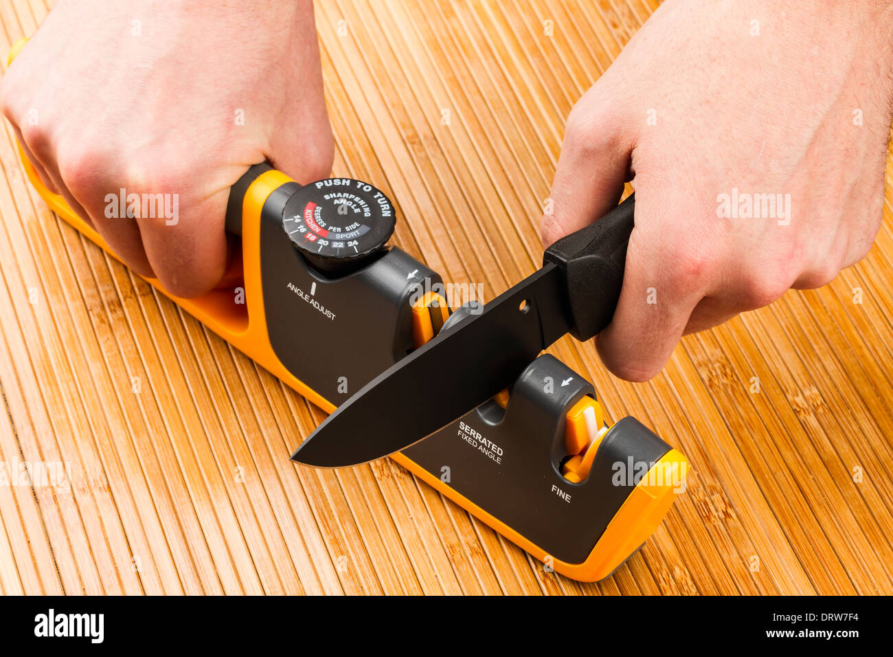 adjustable manual knife sharpener on wooden background Stock Photo