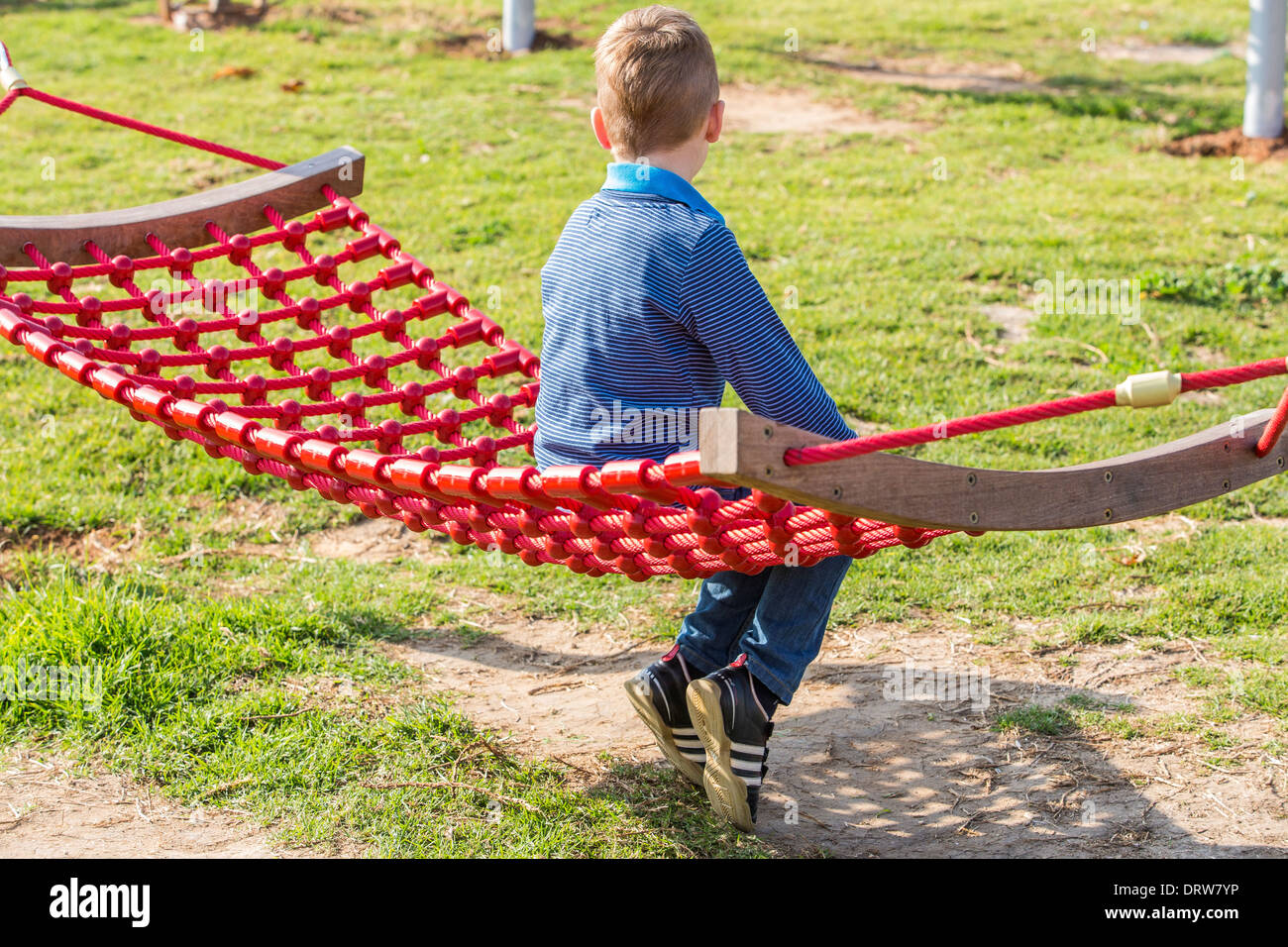 Red haired boy on a hammock in a garden Stock Photo