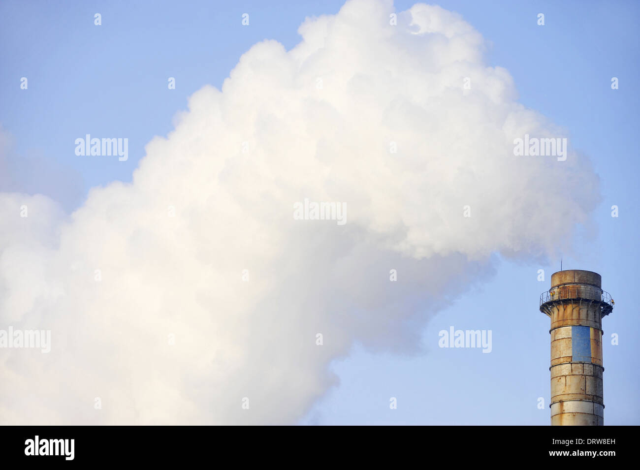 Industrial chimney releasing a huge amount of smoke Stock Photo