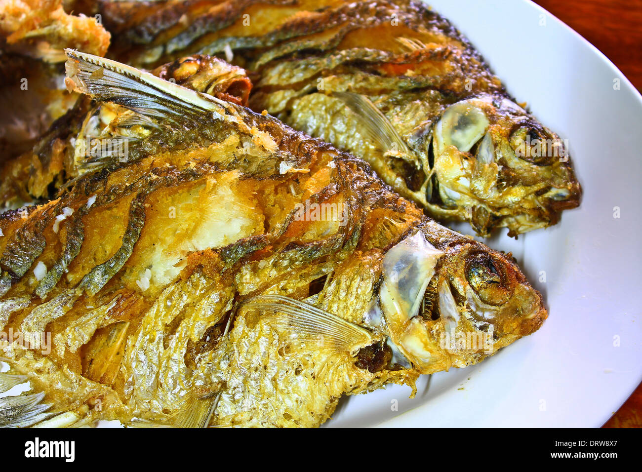 Two Fried fish for dinner Stock Photo - Alamy
