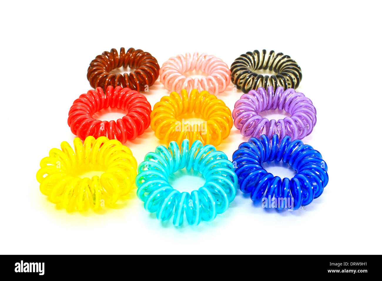 Spiral colorful elastic hair ties used on a white background. Stock Photo