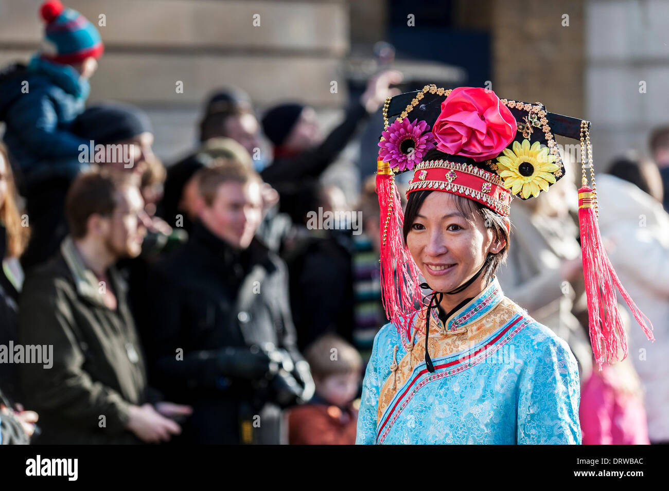 Charing Cross Rd, London, UK. 2nd February 2014. An attractive Chinese woman wearing traditional dress during the celebrations for the Chinese New Year, the Year of the Horse. Credit:  Gordon Scammell/Alamy Live News Stock Photo