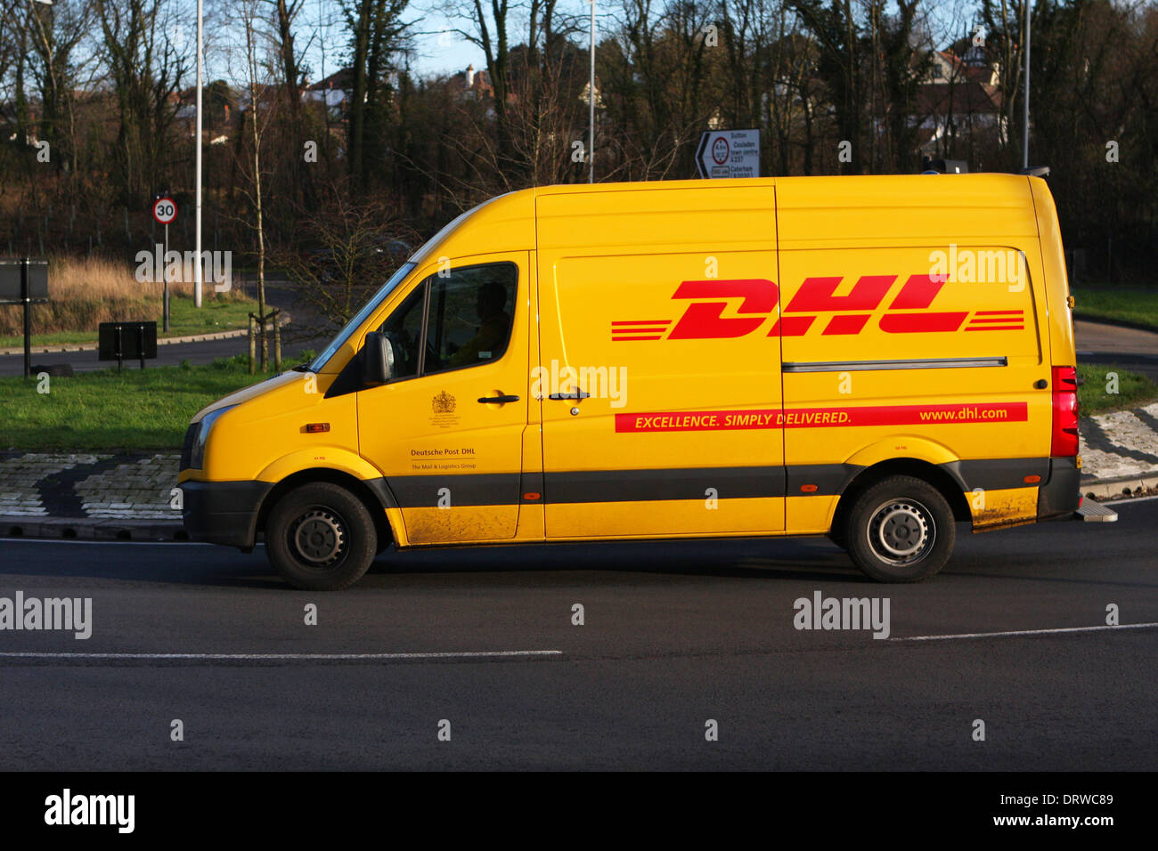 A DHL van traveling around a roundabout in Coulsdon, Surrey, England. Stock Photo