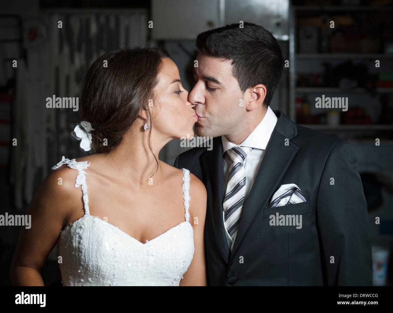 Wedding couple kissing each other indoors Stock Photo