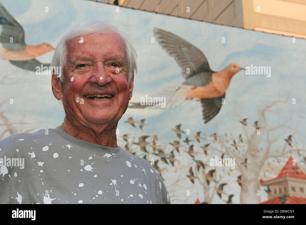 Wildlife artist John Ruthven with passenger pigeon mural on Cincinnati