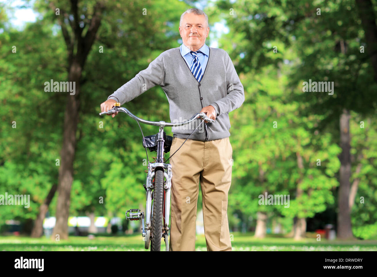 Mature man with his bicycle in a park Stock Photo