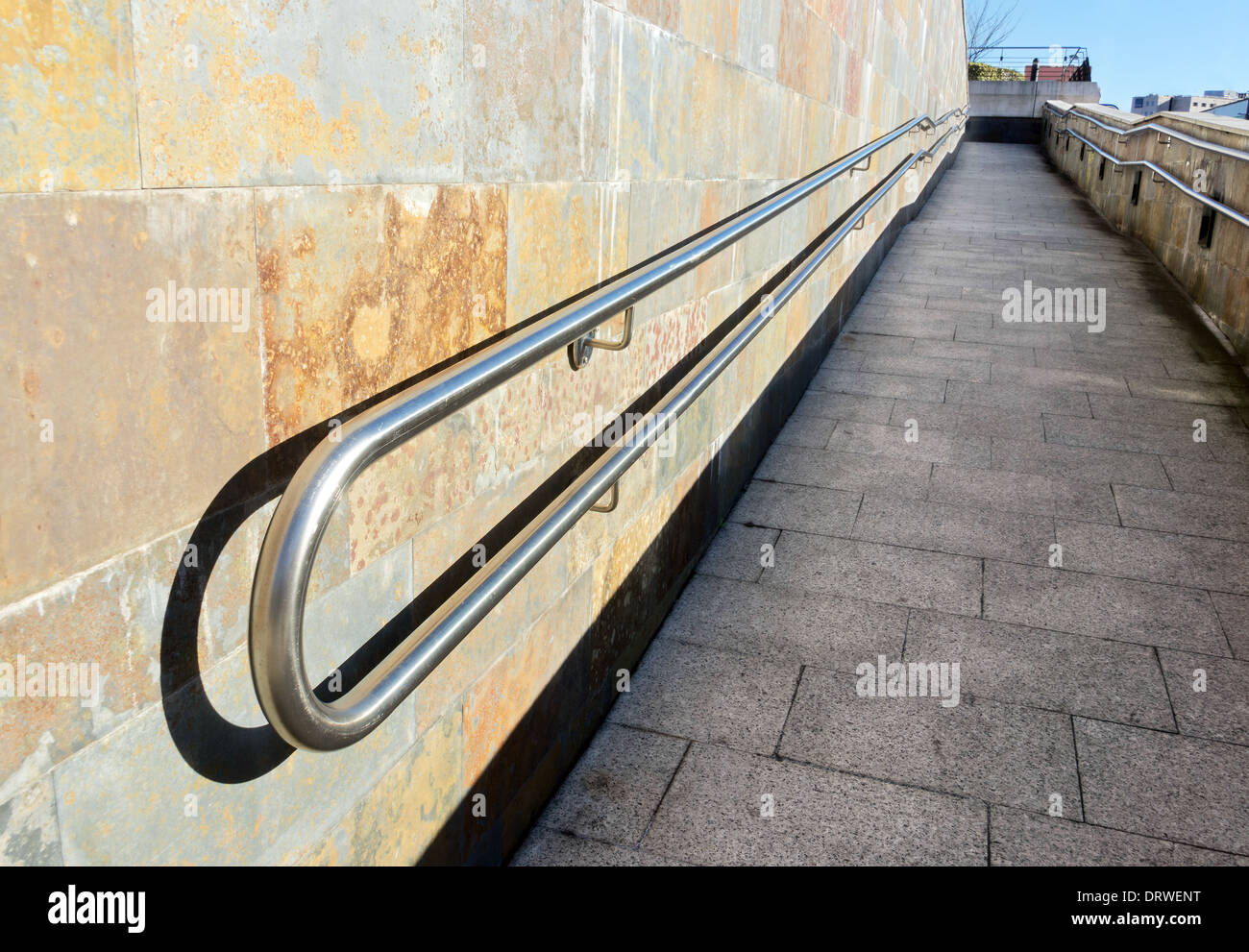 metal railings on a slope of pedestrian walkway Stock Photo