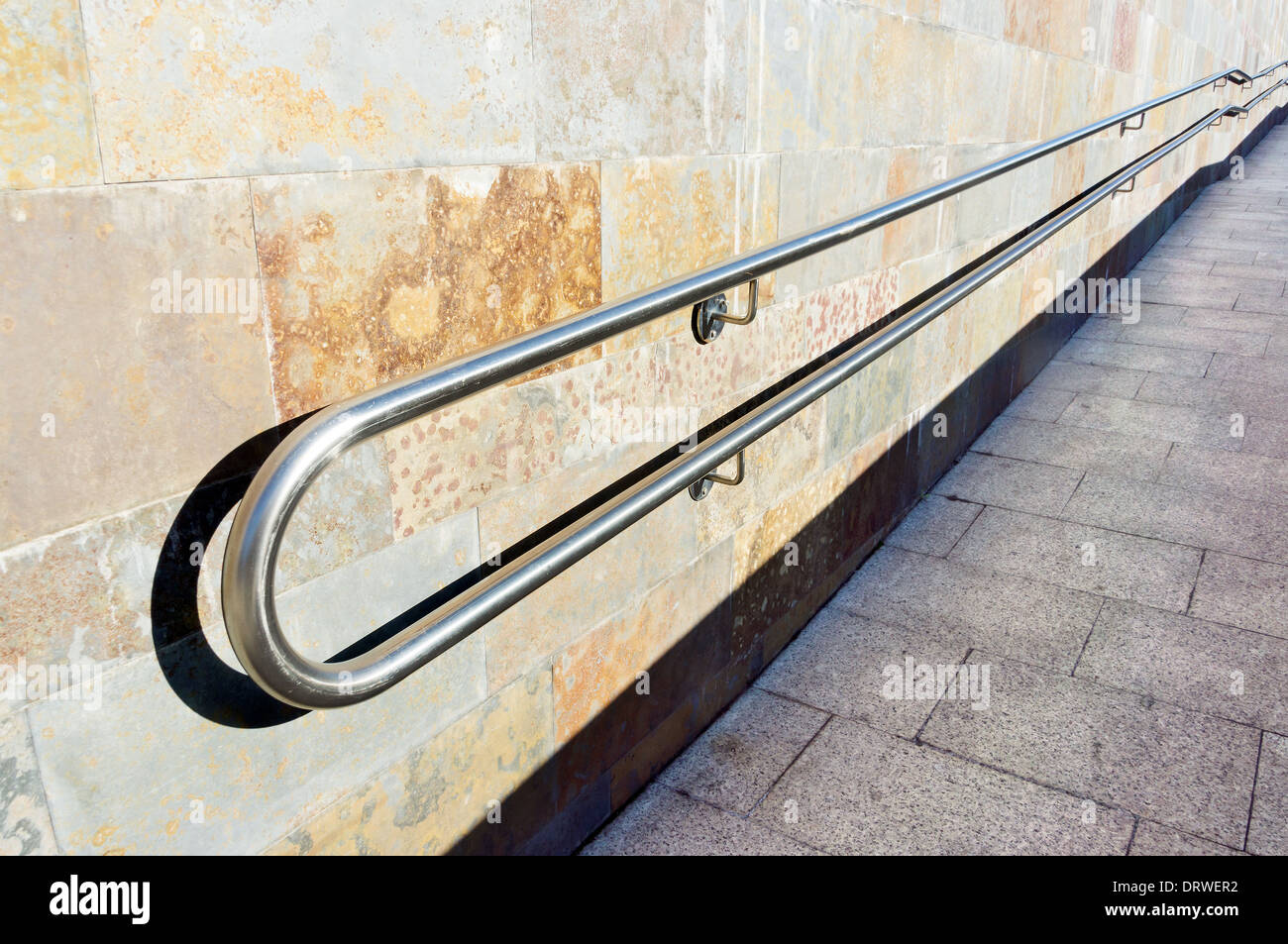 metal railings on a slope of pedestrian walkway Stock Photo
