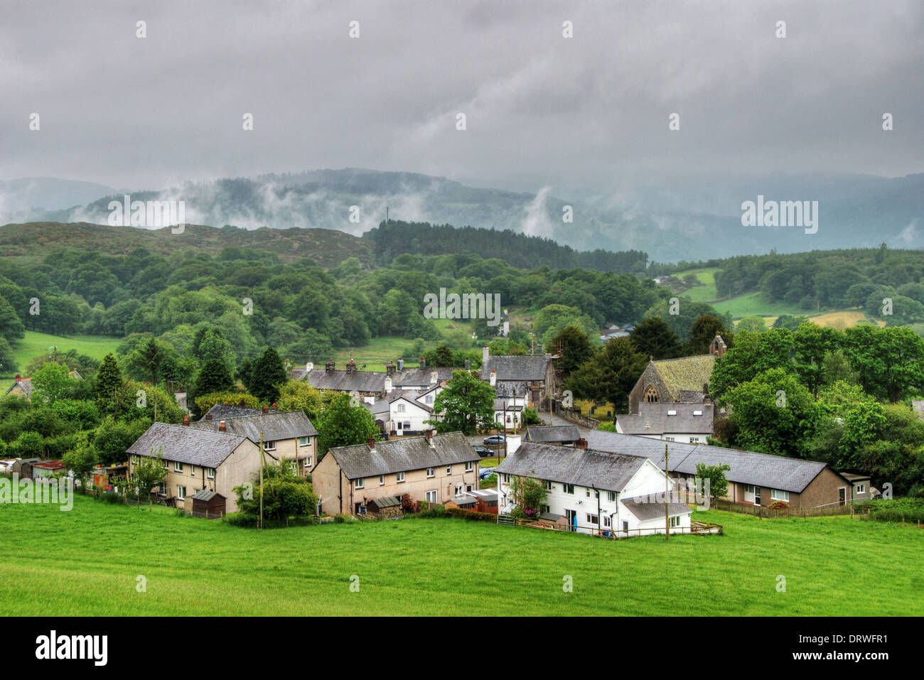 Rain clouds and fog over a small village in North Wales Stock Photo