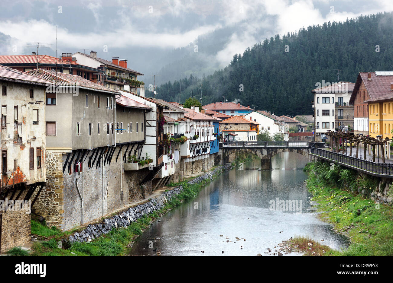 Orozko village in Basque Country with river and a bridge in foggy and rainy day Stock Photo